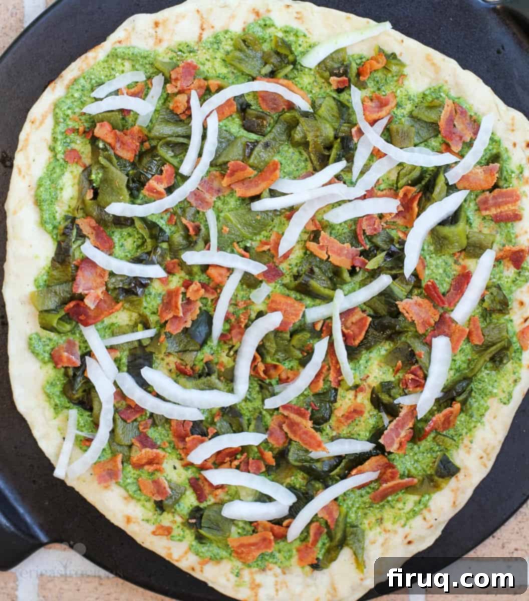 Smoky Roasted Poblano Pizza 4 pizza crust with cilantro pesto, roasted poblanos, bacon, and onion before adding cheese