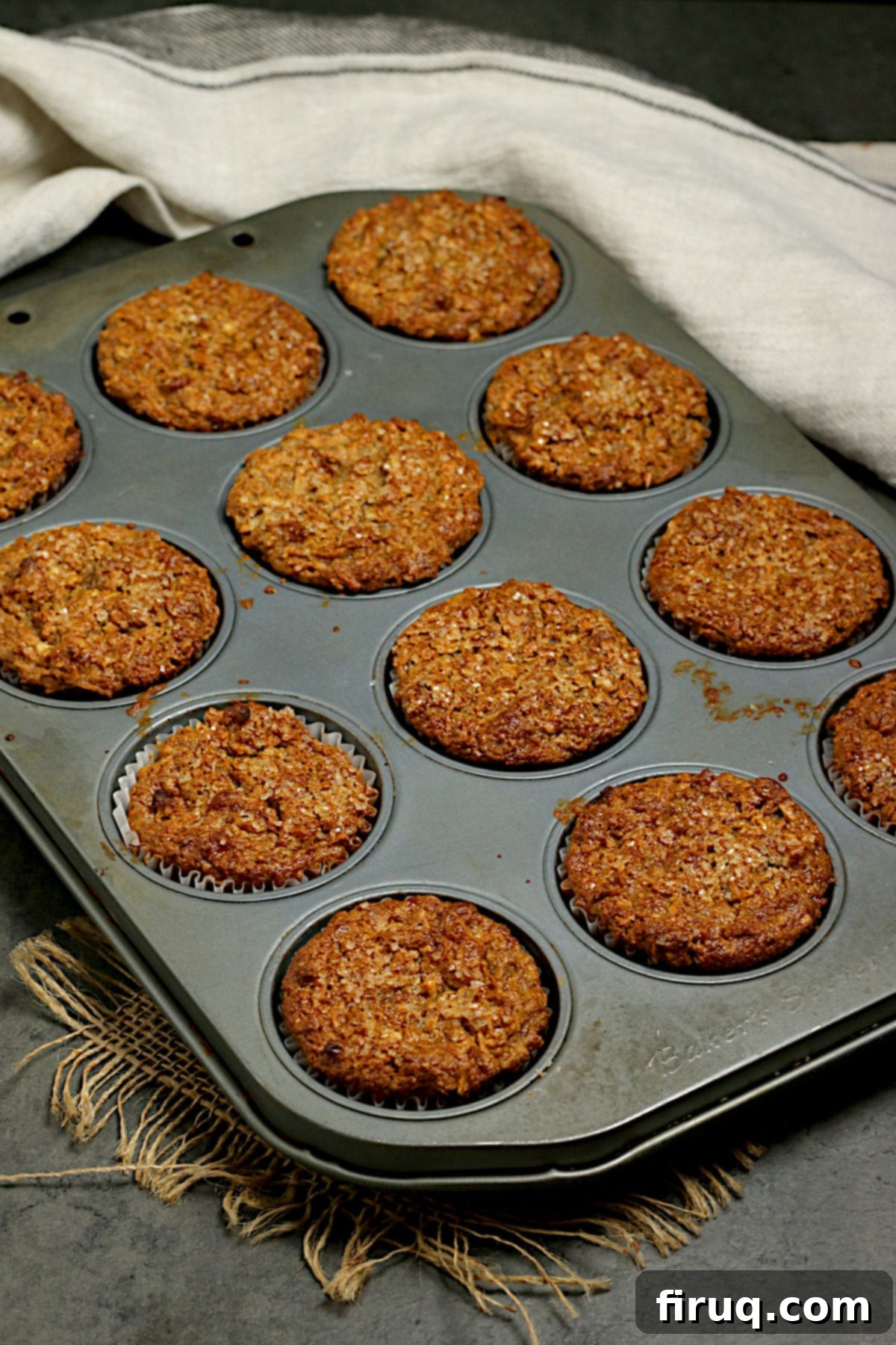 Egg-Free Apple Cinnamon Oatmeal Muffins in Pan Freshly baked Egg-Free Apple Cinnamon Oatmeal Muffins cooling in a muffin pan, showcasing their golden-brown tops and inviting texture. Perfect for a healthy breakfast or snack.
