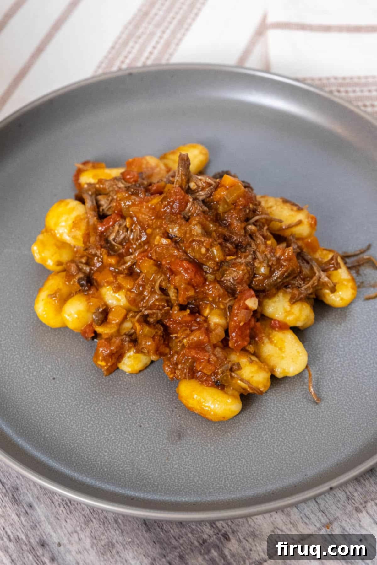 Braised Italian Short Ribs with Gnocchi 2 Italian short ribs served over gnocchi, a rich ragu sauce clinging to tender potato gnocchi