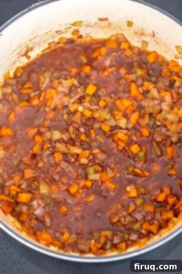 Braised Italian Short Ribs with Gnocchi 7 Red wine simmering and reducing in the Dutch oven