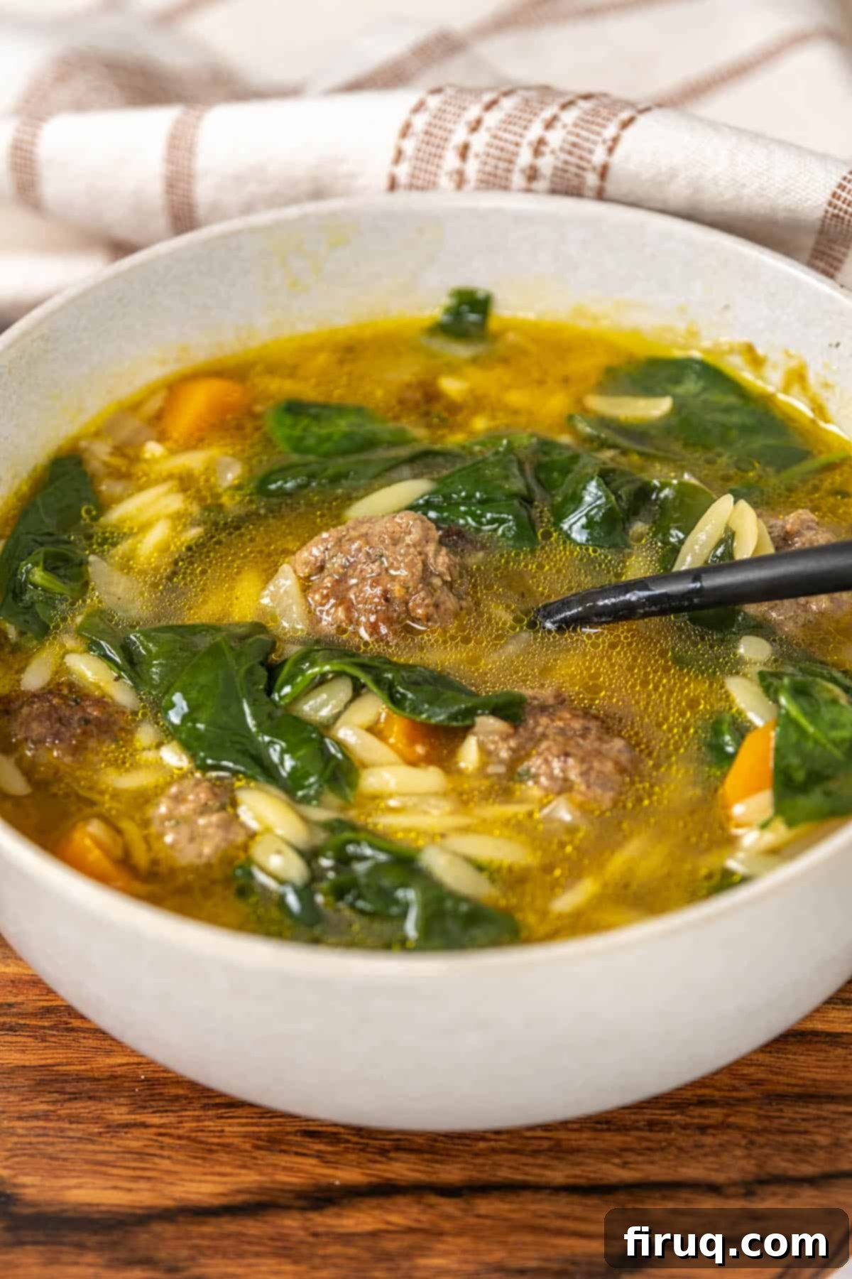 Classic Italian Wedding Soup 2 A vibrant bowl of homemade Italian Wedding Soup with small meatballs, orzo, and fresh spinach.