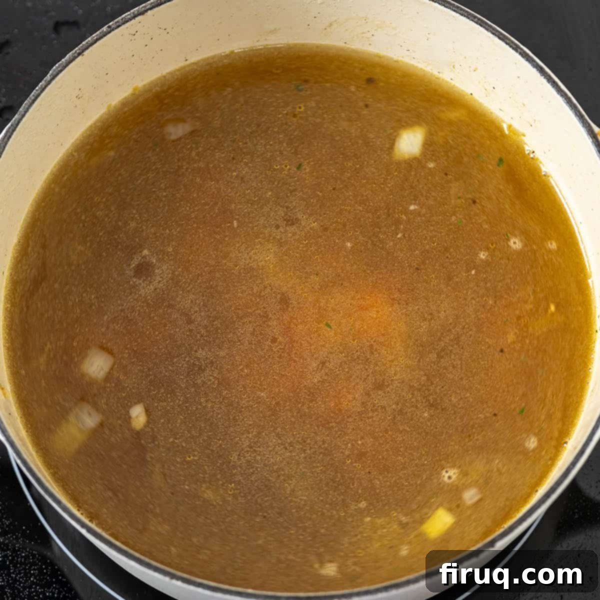Classic Italian Wedding Soup 6 Chicken broth being poured over sautéed vegetables in a pot