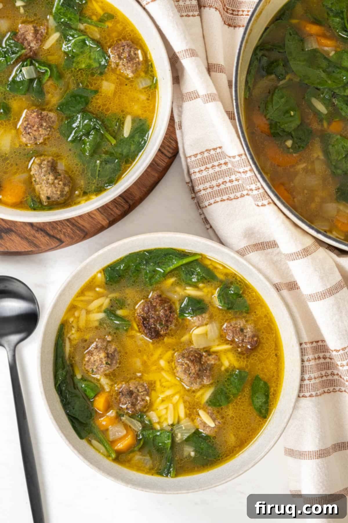 Classic Italian Wedding Soup 8 A bowl of Italian wedding soup served, showing the meatballs, orzo, and spinach clearly.