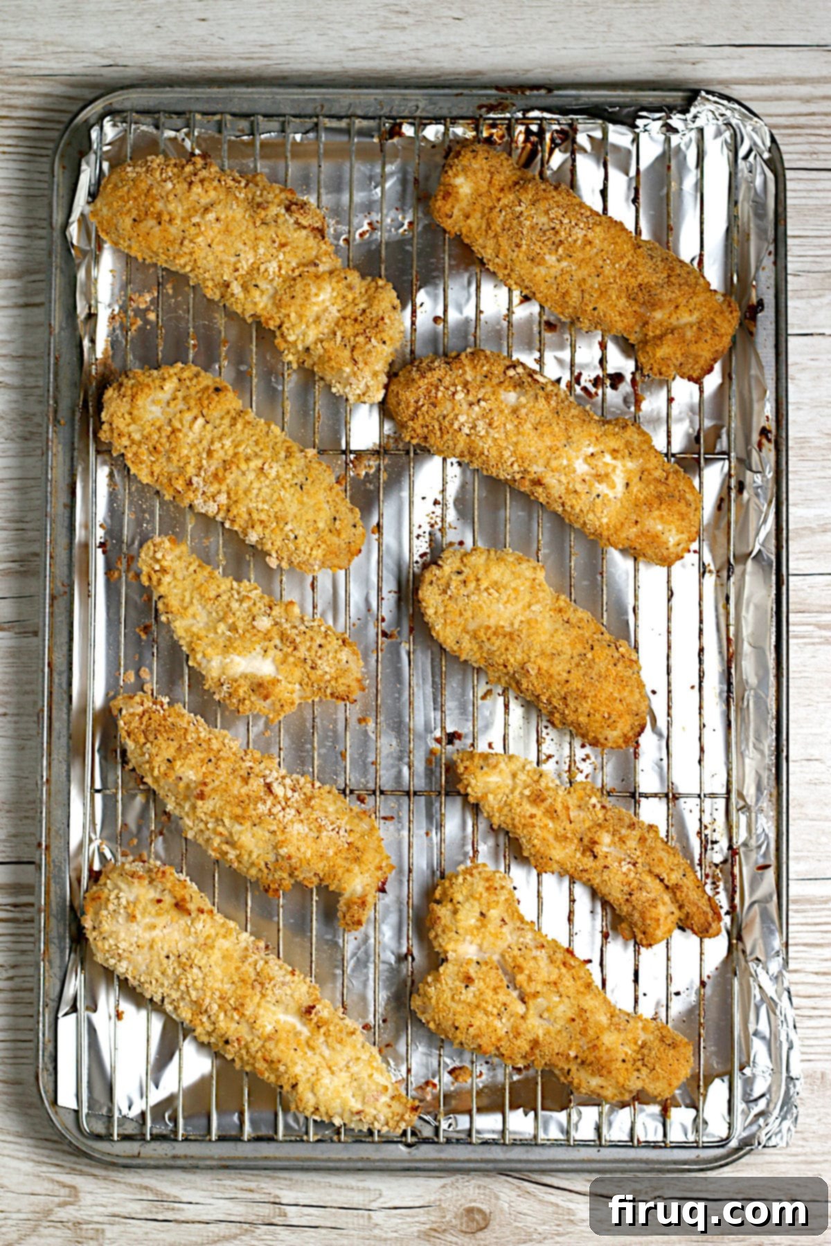 Crunchy Oven-Baked Chicken Tenders on a Baking Sheet Oven-baked chicken tenders on a baking sheet.