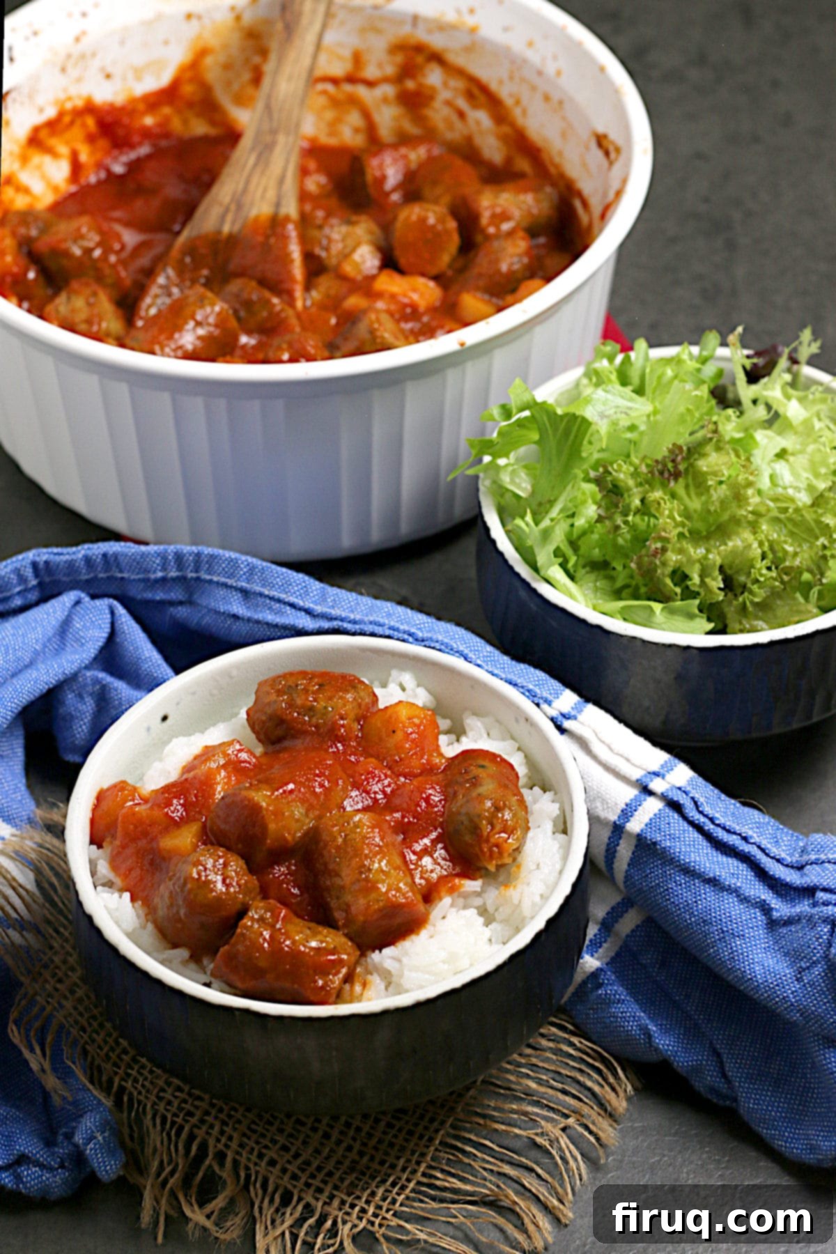 Peachy Sweet and Sour Sausages with Rice Peachy Sweet and Sour Sausages over white rice in a black bowl.