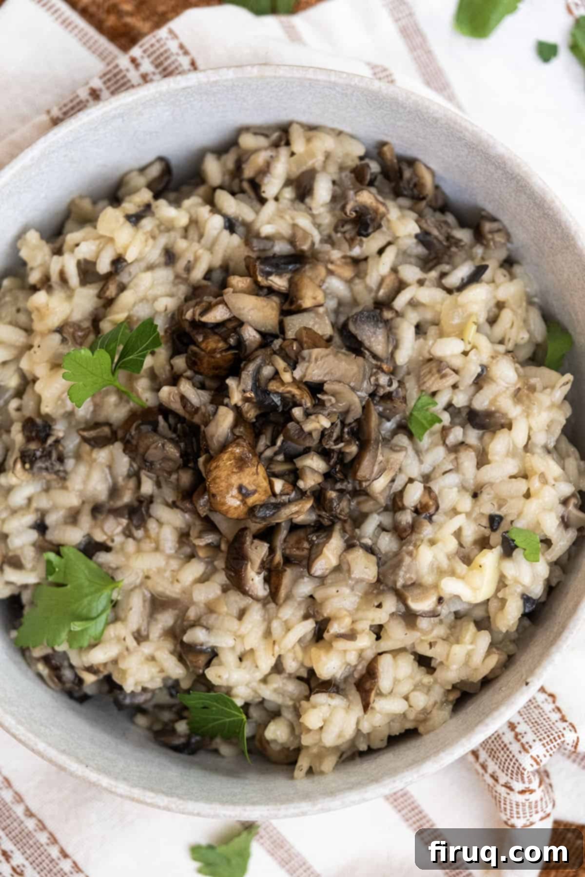 Decadent Mushroom Truffle Risotto 11 The final dish of creamy mushroom truffle risotto, topped with fresh parsley for garnish.