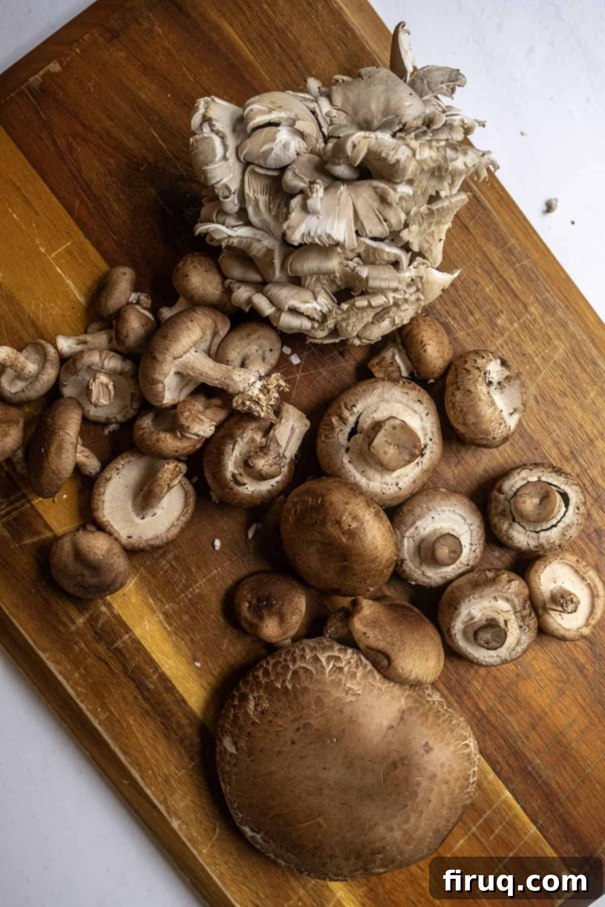 Decadent Mushroom Truffle Risotto 3 A selection of fresh, gourmet mushrooms including baby bella, shiitake, oyster, and portobello, ready for the risotto.