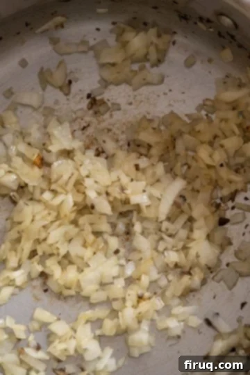 Decadent Mushroom Truffle Risotto 6 Minced onions gently sautéing in olive oil in the saucepan.