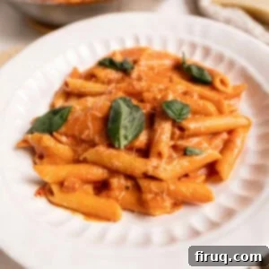Fiery Vodka Sauce 10 A perfectly plated serving of penne with spicy vodka sauce, topped with fresh herbs and cheese.