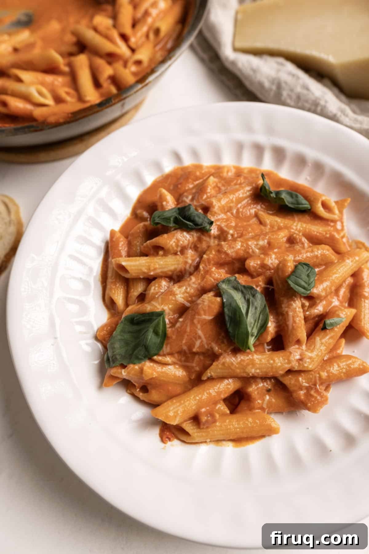 Fiery Vodka Sauce 8 A serving of penne pasta with creamy, spicy vodka sauce on a white plate, ready to be enjoyed.