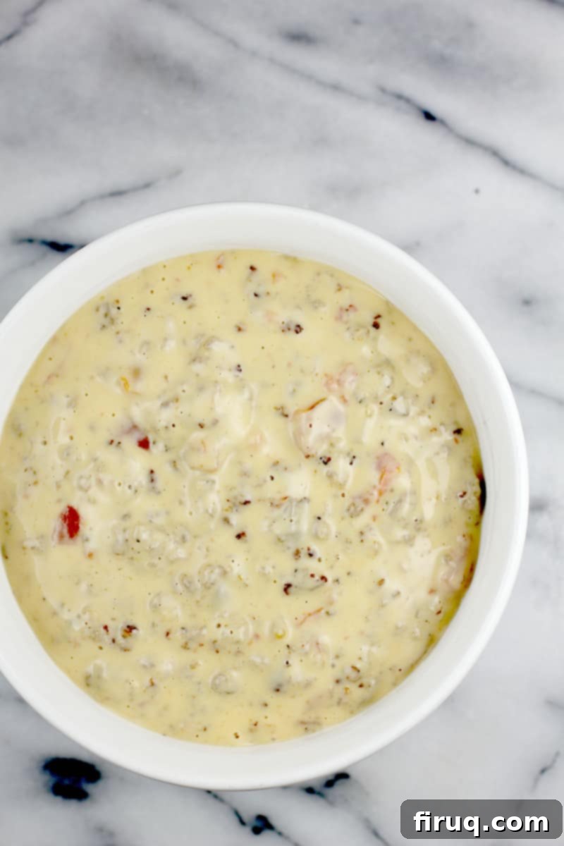 Irresistible Velveeta Rotel Sausage Dip 11 White bowl on marble surface, overhead view to show finished queso