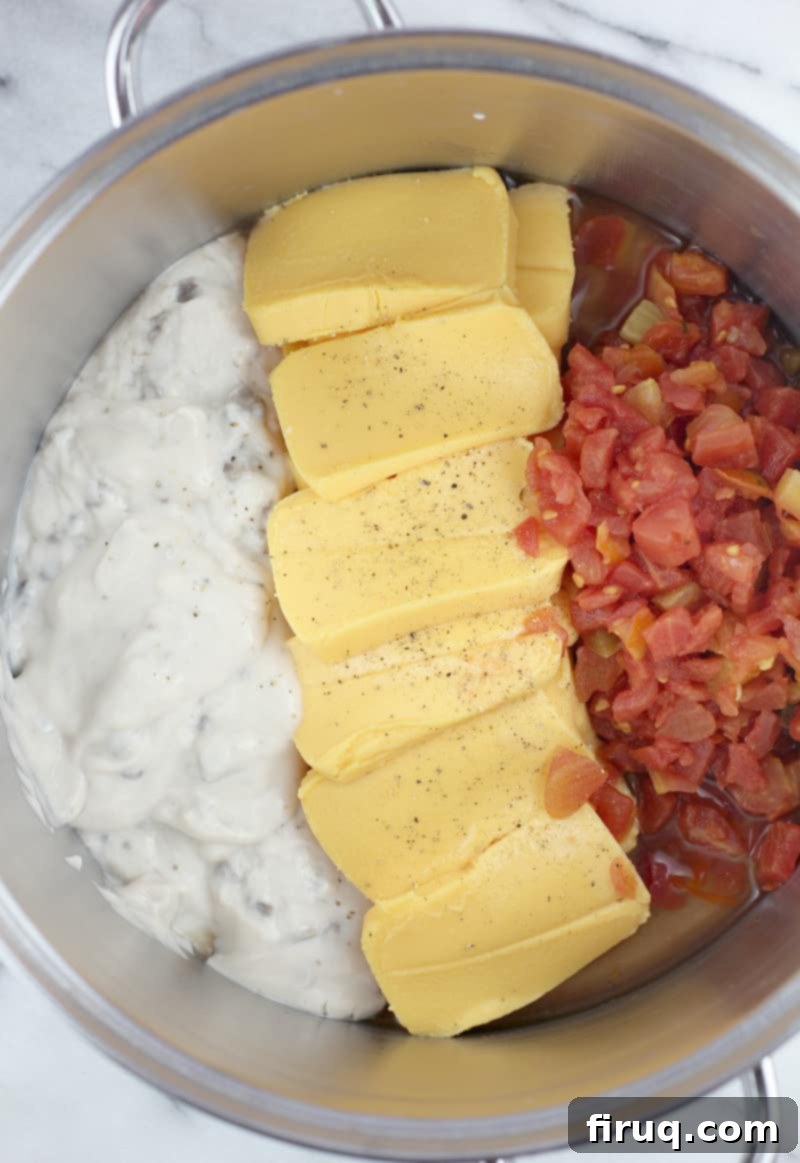 Irresistible Velveeta Rotel Sausage Dip 7 Cheese, condensed soup, and Rotel in a pot before heating
