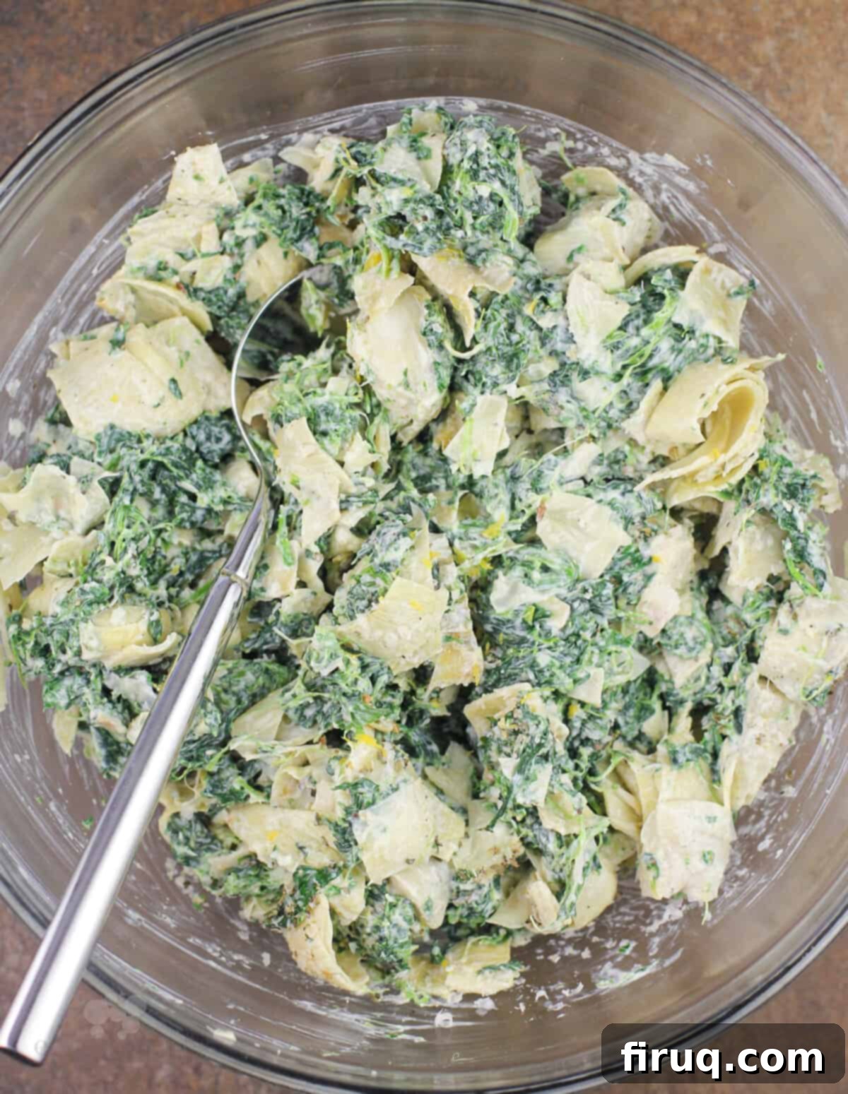 Creamy Spinach Artichoke Indulgence 4 spinach artichoke dip in a glass bowl with fork