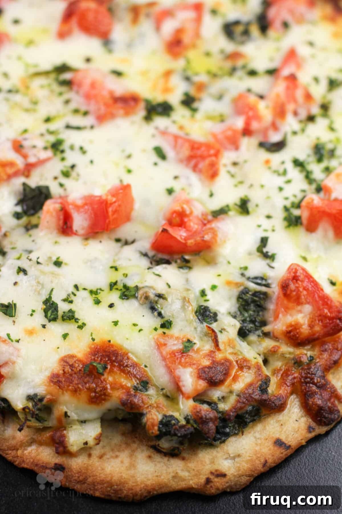 Creamy Spinach Artichoke Indulgence 6 prepared pizza on pizza stone