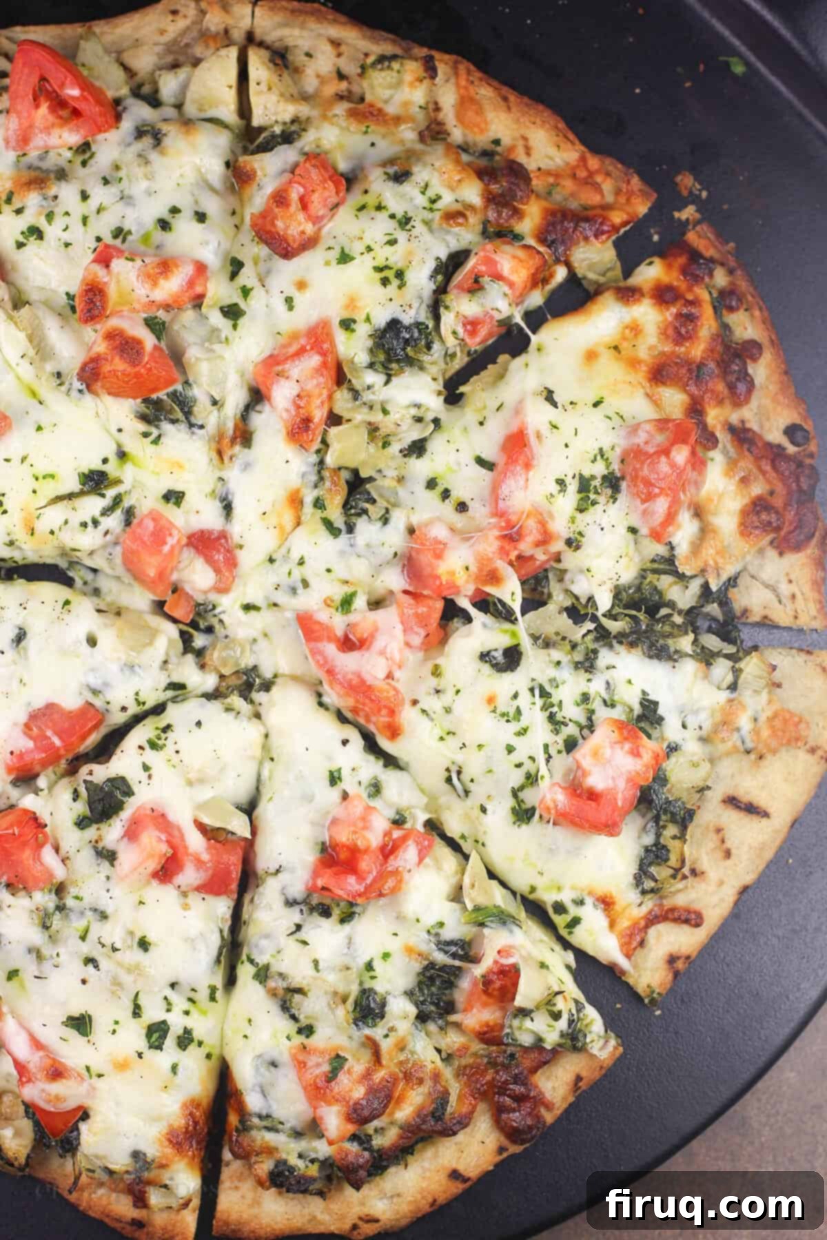Creamy Spinach Artichoke Indulgence 8 sliced pizza on pizza stone