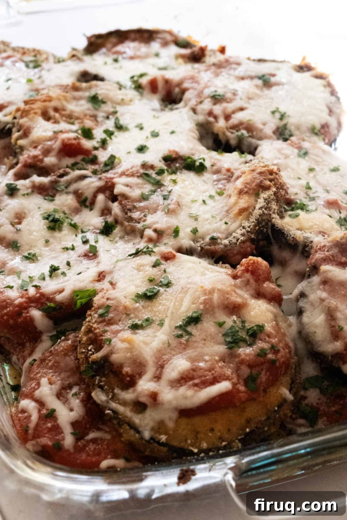 The Ultimate Homemade Eggplant Parmigiana 11 Close-up of baked eggplant parmesan with bubbling, melted mozzarella cheese.