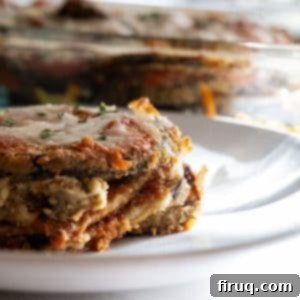 The Ultimate Homemade Eggplant Parmigiana 13 A delectable close-up of Eggplant Parmigiana, rich with melted cheese and sauce.