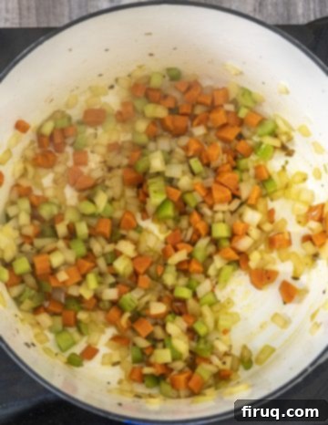 Hearty Italian Sausage and Tortellini Soup 5 sauteing carrots, onions and celery with garlic
