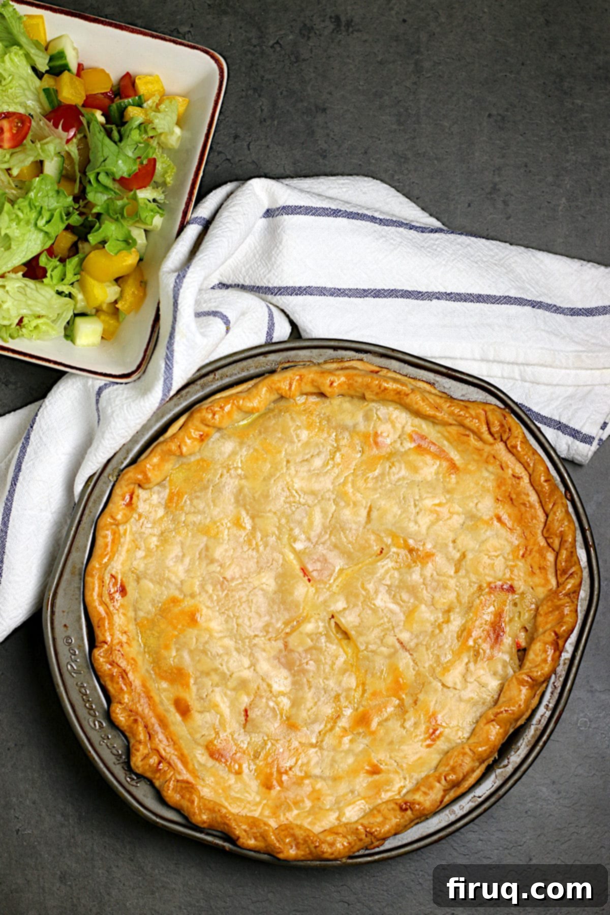 Golden-Brown Seafood Pie Overhead photo of a whole golden-brown seafood pie in a pie pan, ready to be sliced.