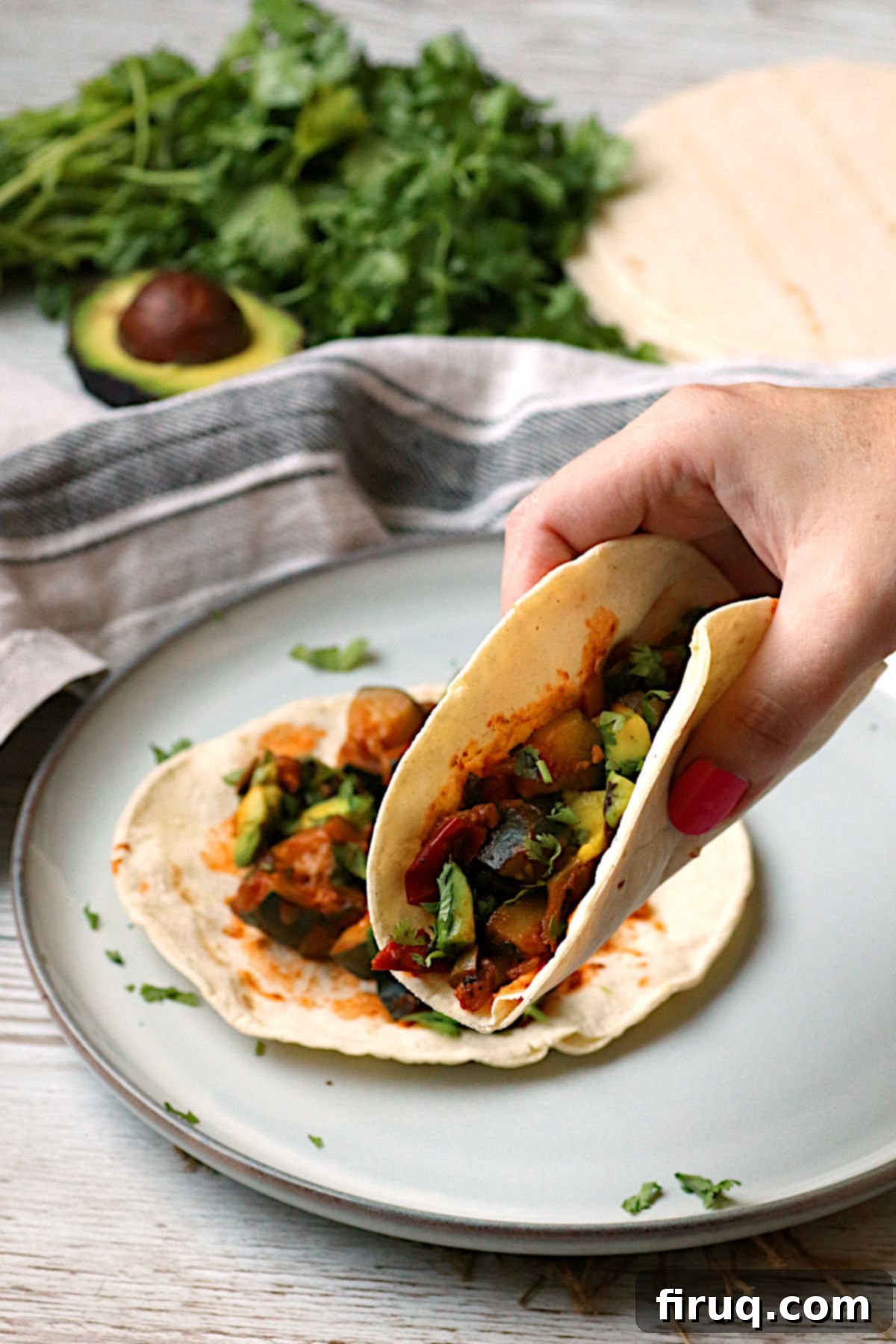 Spicy Zucchini Tacos Recipe A hand holding a Spicy Zucchini Taco, emphasizing the unique use of zucchini in a savory dish.