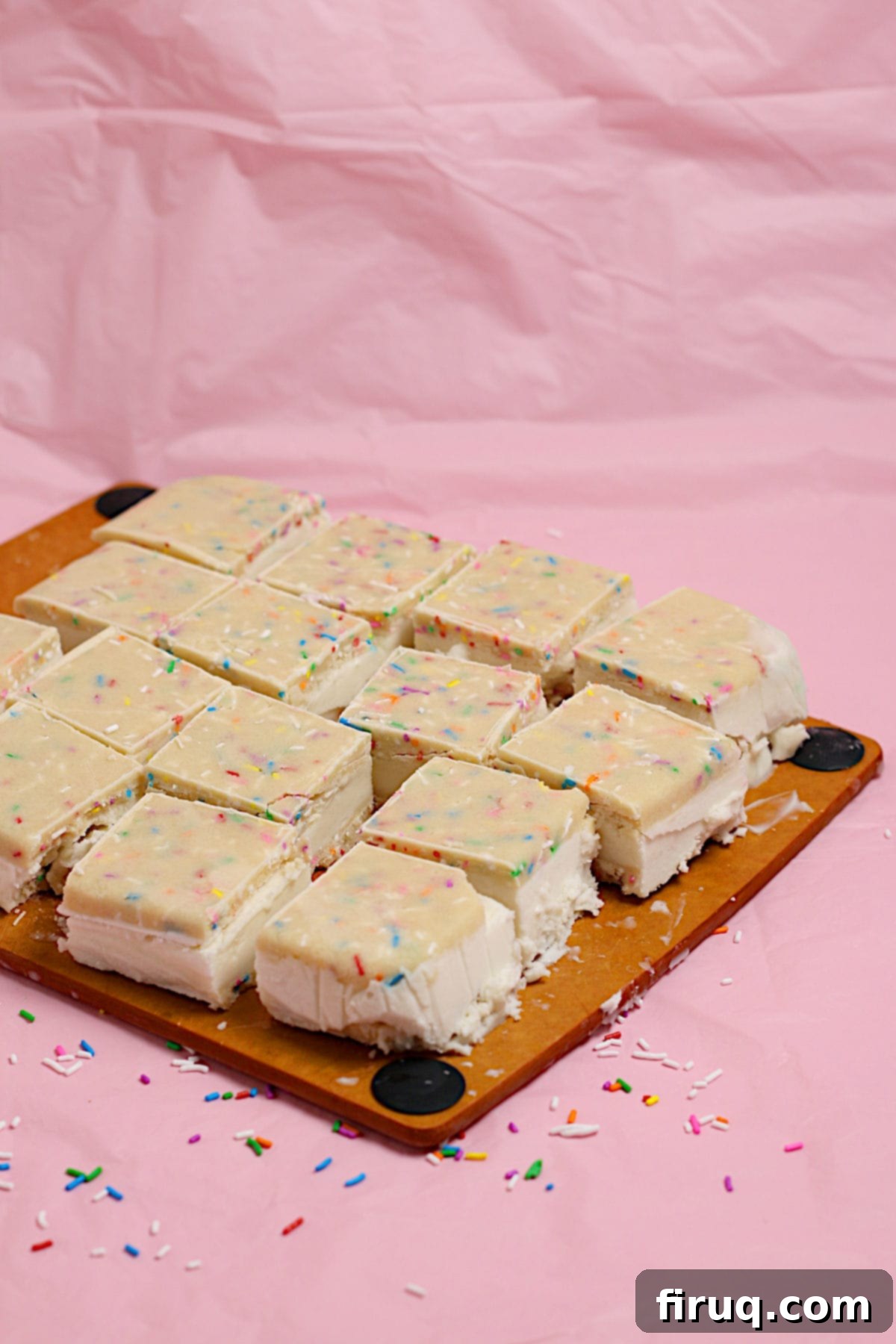 Funfetti Cookie Dough Ice Cream Sandwiches Small square funfetti cookie dough ice cream sandwiches on a cutting board, showcasing vibrant sprinkles.