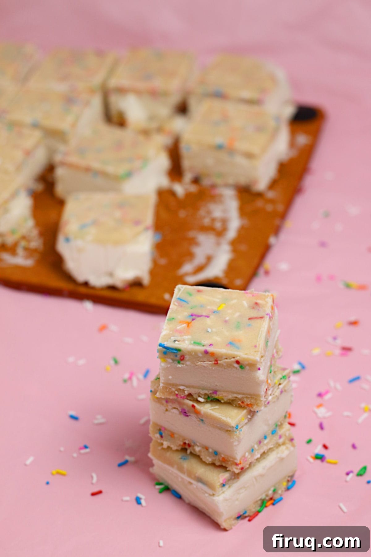 Stacked Funfetti Cookie Dough Ice Cream Sandwiches Small square funfetti cookie dough ice cream sandwiches in a stack, ready to be served or stored.