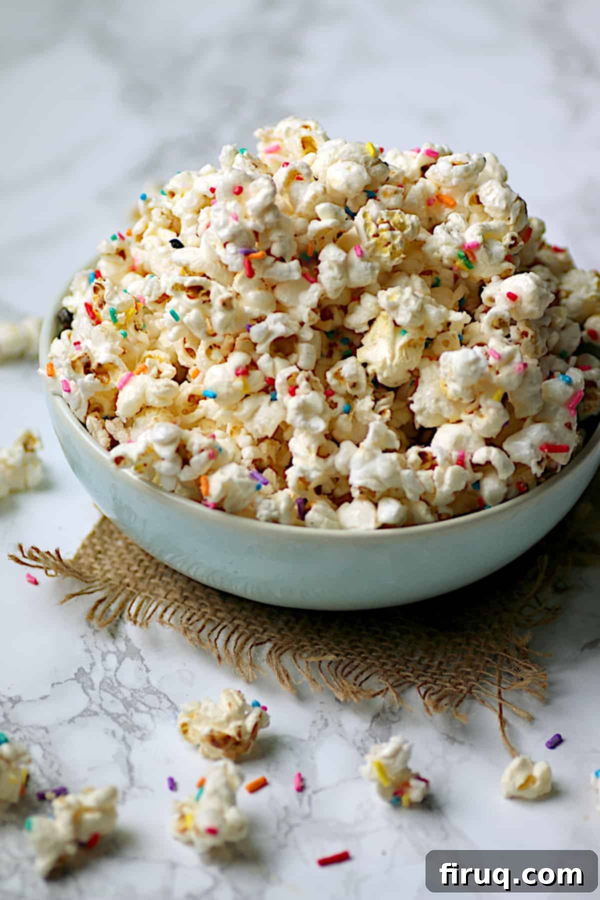 Funfetti Popcorn Homemade funfetti popcorn in a pale blue bowl, colorful and festive.