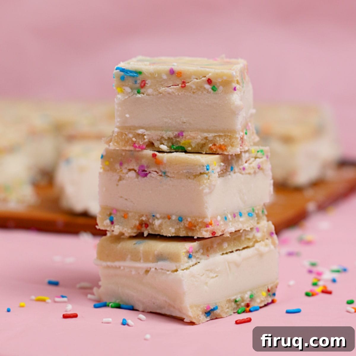 Irresistible Funfetti Cookie Dough Ice Cream Sandwiches 2 Small square funfetti cookie dough ice cream sandwiches in a stack.