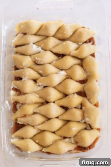 Hearty Stuffed Shells with Bolognese and Ricotta 10 filling the pan with stuffed shells