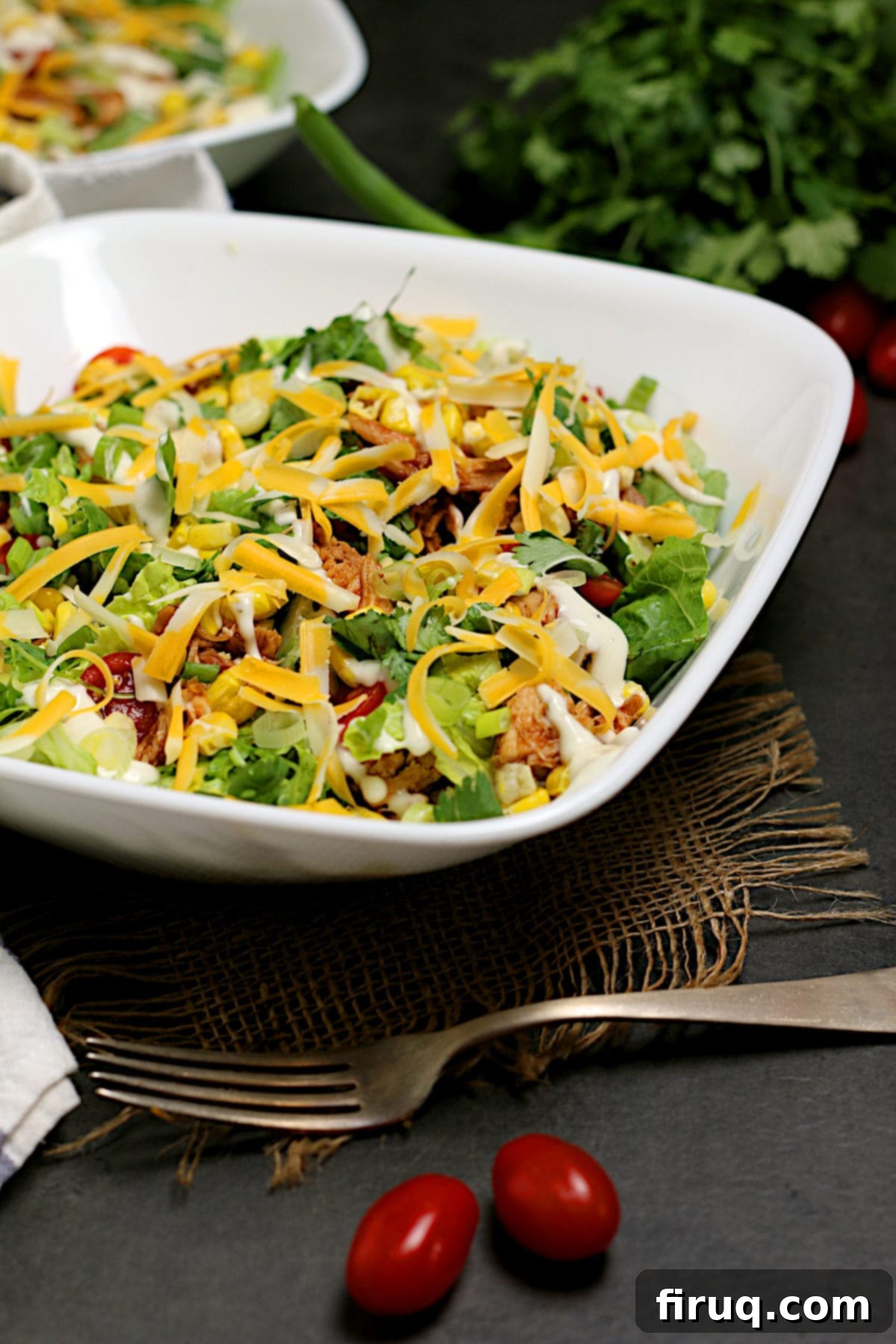 Ready to Serve BBQ Chicken Ranch Salad A single white bowl containing a perfectly assembled Barbecue Chicken Ranch Salad.
