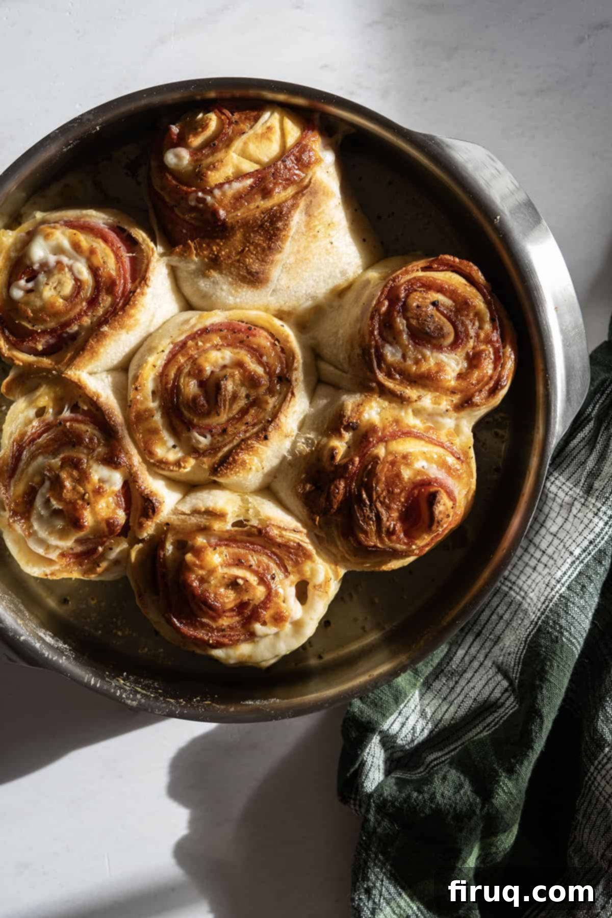 Savory Pepperoni Spiral 2 Golden brown pepperoni stromboli, sliced and arranged beautifully on a serving platter, ready to enjoy.