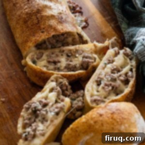 Savory Italian Sausage Bread 10 A freshly baked and sliced Italian sausage bread, ready to serve.