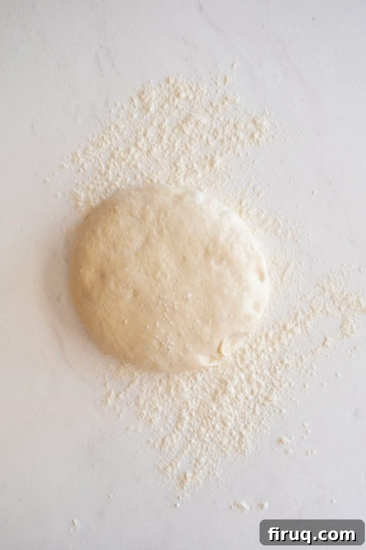 Savory Italian Sausage Bread 3 A smooth, round ball of fresh pizza dough, ready to be rolled out.
