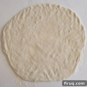 Savory Italian Sausage Bread 4 Pizza dough rolled out thinly on a floured surface.