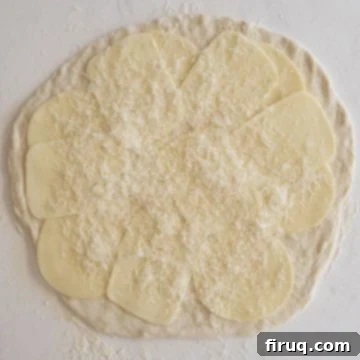 Savory Italian Sausage Bread 5 Pizza dough topped with layers of mozzarella, provolone, and parmesan cheese.