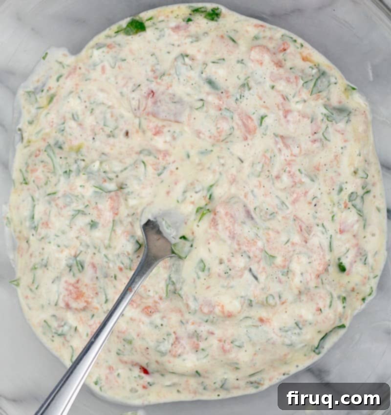 Exquisite Smoked Salmon Tartlets 4 the combined filling in a clear glass bowl with a fork