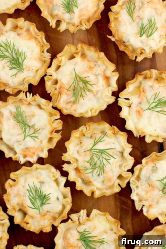 Exquisite Smoked Salmon Tartlets 7 top down view a tray full of mini smoked salmon tarts with dill garnish