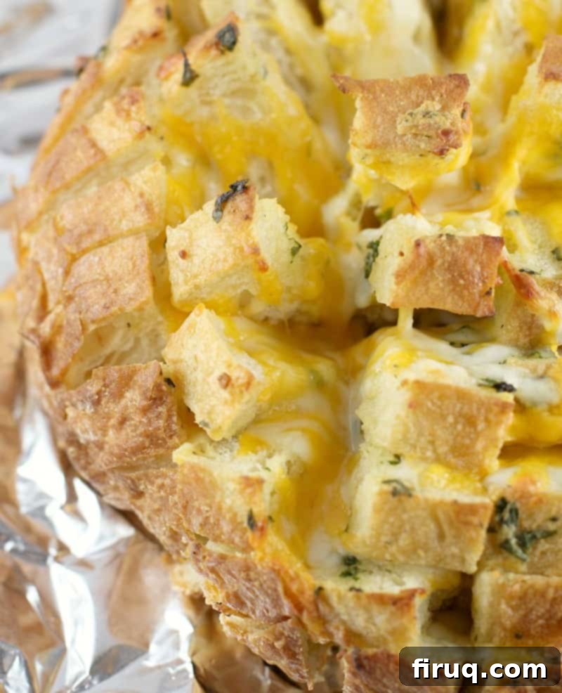 Loaded Cheesy Garlic Bread 12 Top-down, zoomed view of the finished garlic cheese bread on foil, highlighting its delicious texture and golden crust.