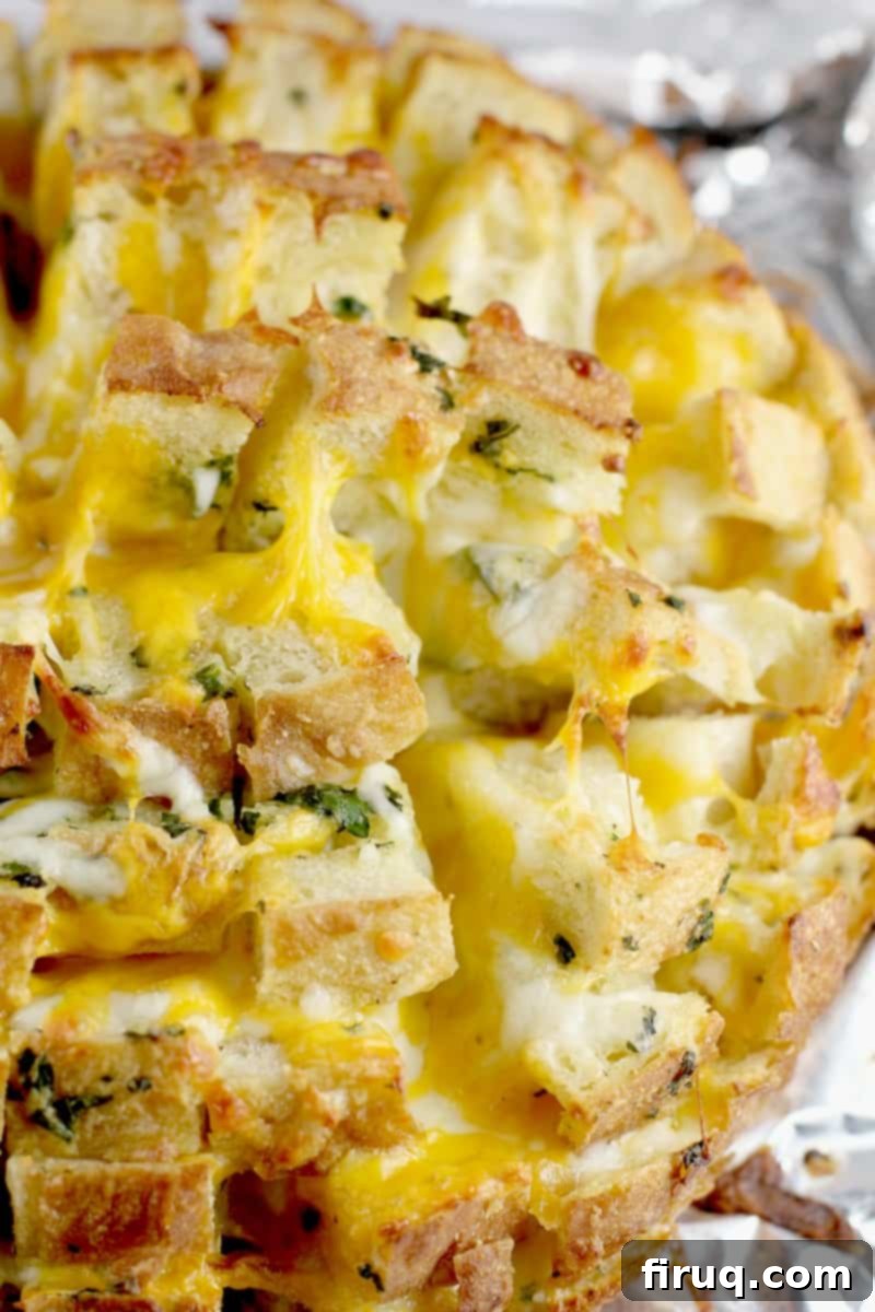 Loaded Cheesy Garlic Bread 3 Top-down, zoomed-in view of the perfectly cooked cheesy garlic bread, showing the melted cheese bubbling in the crevices.