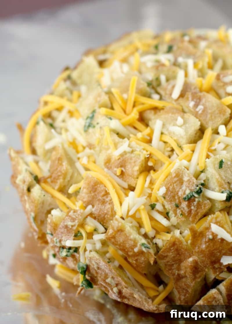 Loaded Cheesy Garlic Bread 7 Side view of the prepared stuffed bread, wrapped in foil and ready for baking.