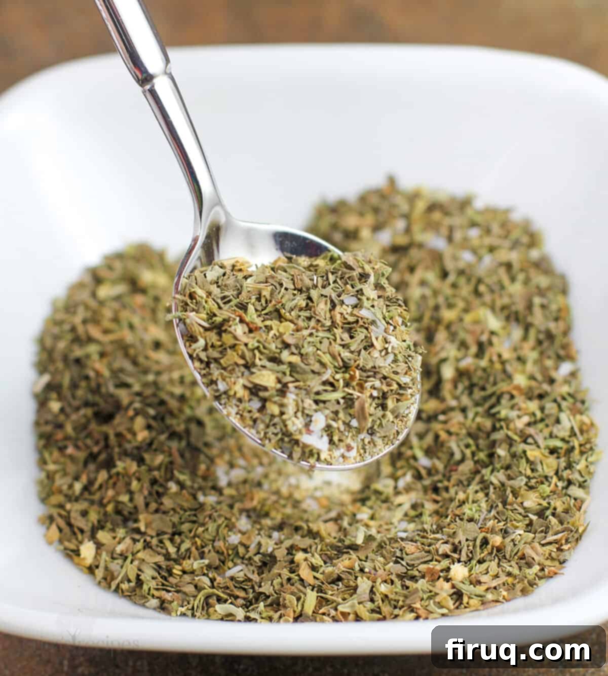 Restaurant Secret Olive Oil Bread Dip 5 spoon mixing ingredients in white bowl
