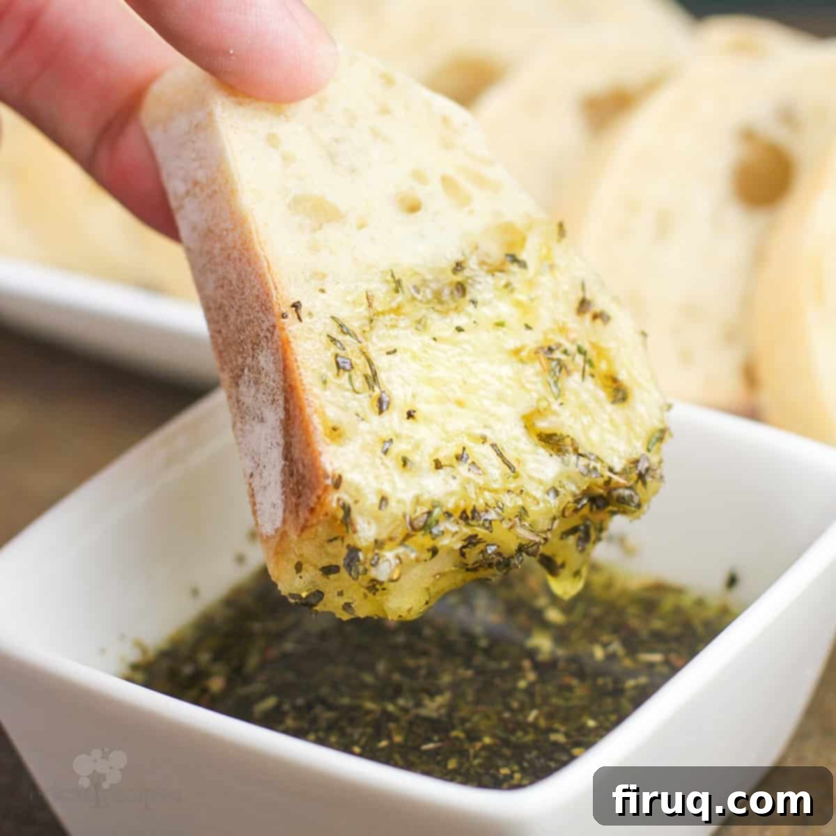 Restaurant Secret Olive Oil Bread Dip 7 bread dipped in a small white bowl with olive oil bread dip