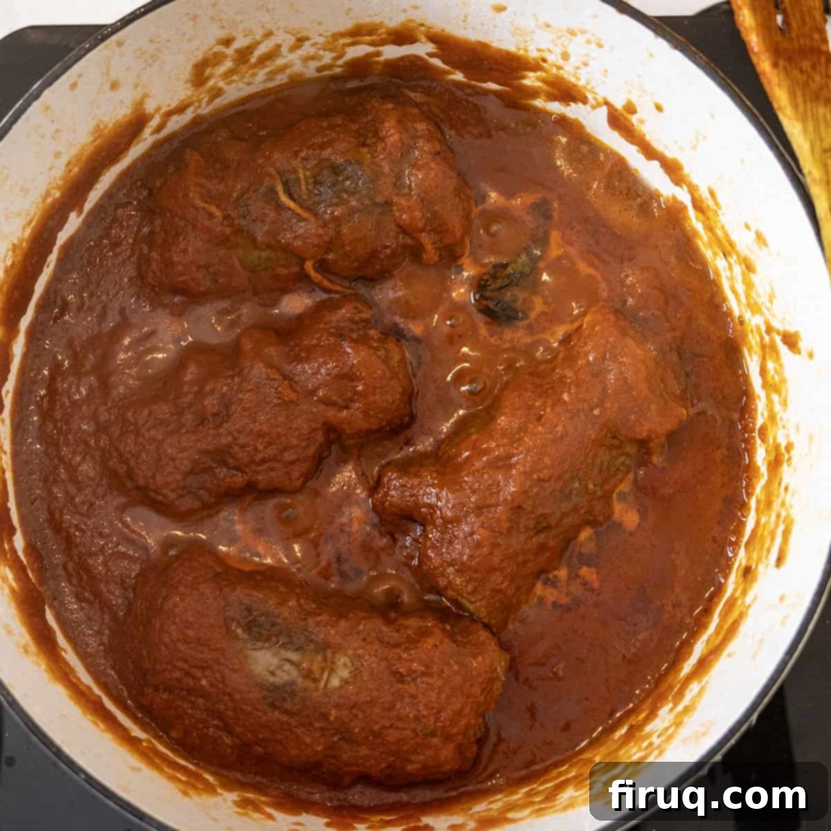 Slow-Simmered Italian Braciole Perfection 12 Braised braciole simmering in rich tomato sauce