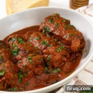 Slow-Simmered Italian Braciole Perfection 14 Italian braciole garnished with parsley, in a bowl with sauce