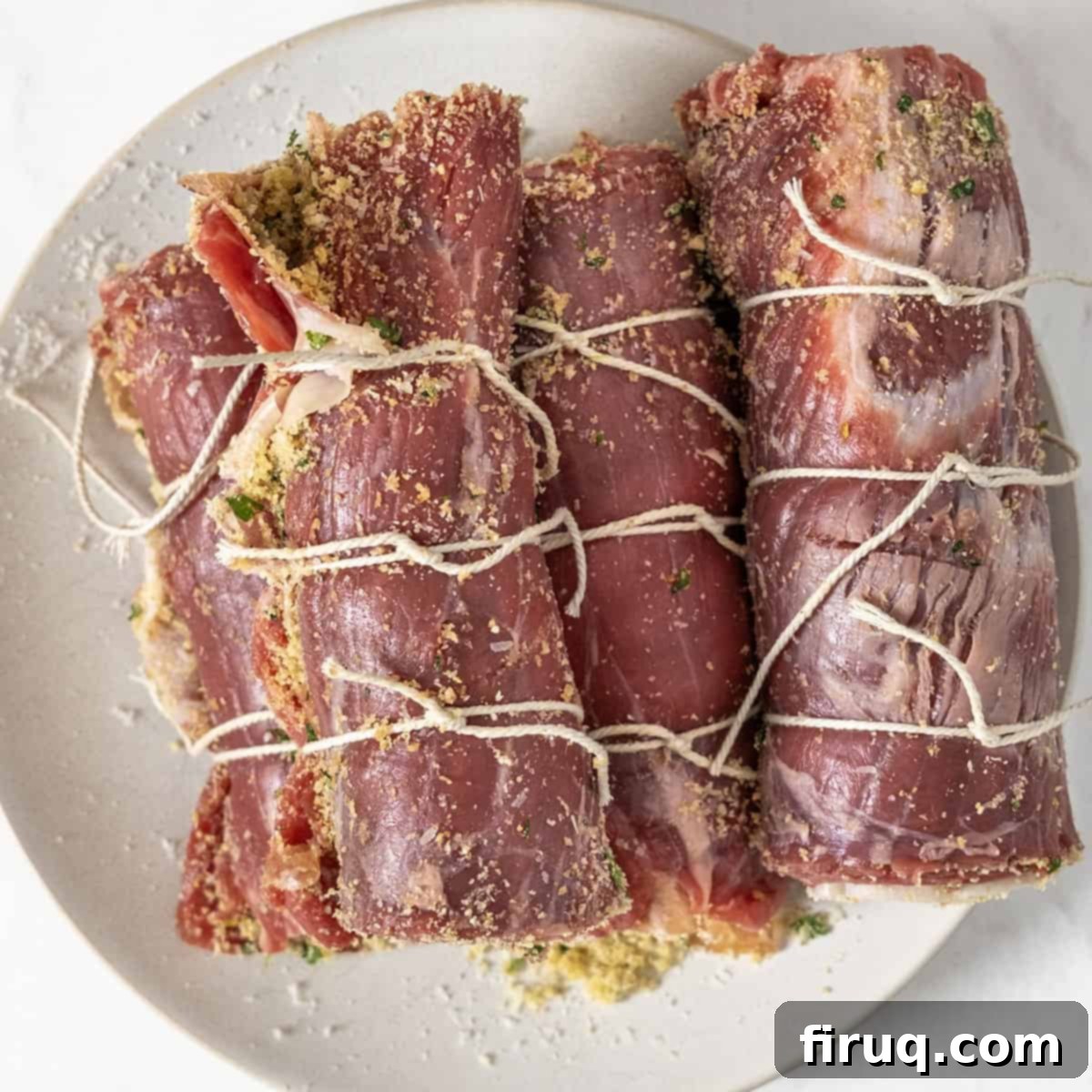 Slow-Simmered Italian Braciole Perfection 7 Rolled and tied bracioles, seasoned and ready for searing