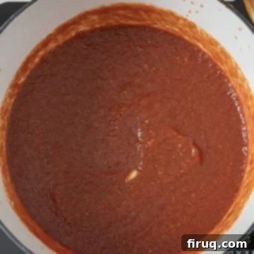 Slow-Simmered Italian Braciole Perfection 10 Tomato sauce simmering for braising braciole