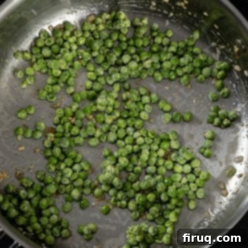Pea and Pancetta Pasta 6 Green peas being added to the pan with sauteed garlic and pancetta fat.