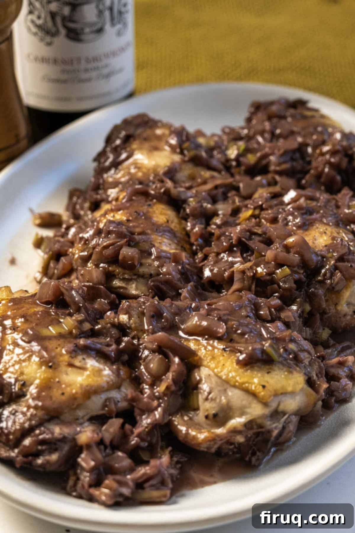 Crimson Wine Fennel Chicken Thighs 2 Crispy skin chicken thighs braised in a rich, creamy red wine and fennel sauce, garnished with fresh herbs.