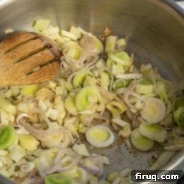 Crimson Wine Fennel Chicken Thighs 4 Sautéing sliced leeks and chopped fennel with shallots until softened and caramelized in a pan.