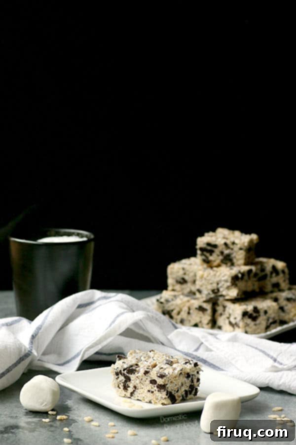 Homemade Cookies and Cream Rice Krispie Treats Delicious Cookies and Cream Rice Krispie Squares arranged on a table, showcasing their delightful texture and Oreo chunks.